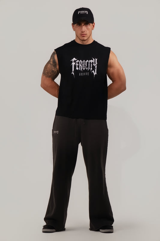Man wearing a black sleeveless shirt with 'Feroce' branding on a gray background