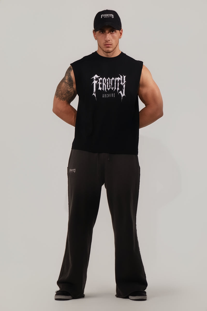 Man wearing a black sleeveless shirt with 'Feroce' branding on a gray background